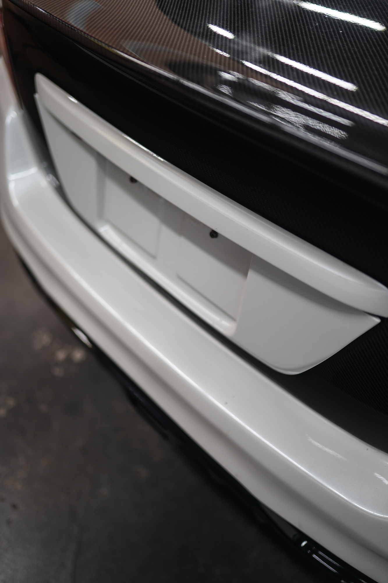 JDMuscle [15-21 WRX/STI] Gloss Black / Paint Matched License Plate Backing